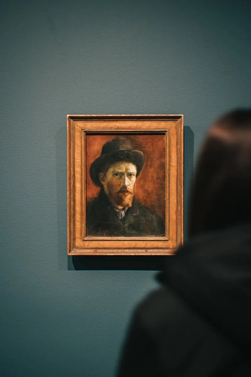 A framed self-portrait of Van Gogh on a gallery wall