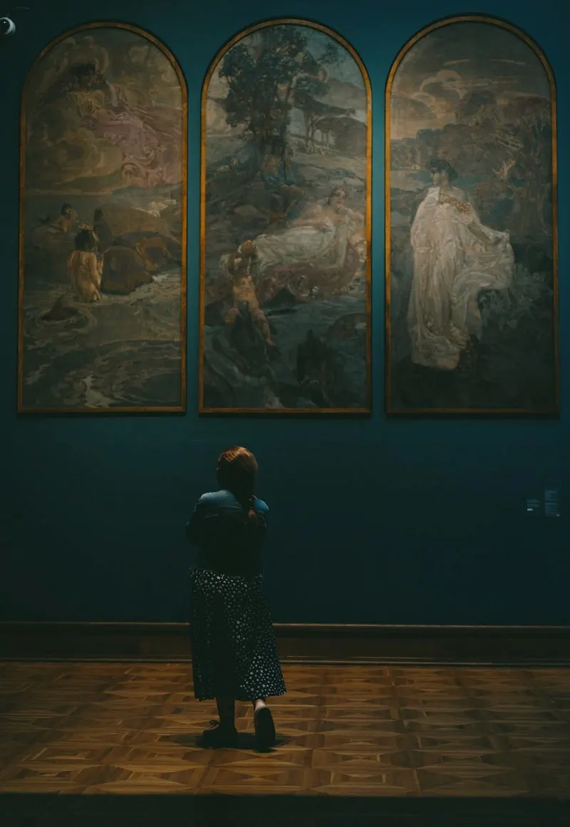 A visitor in front of a large triptych
